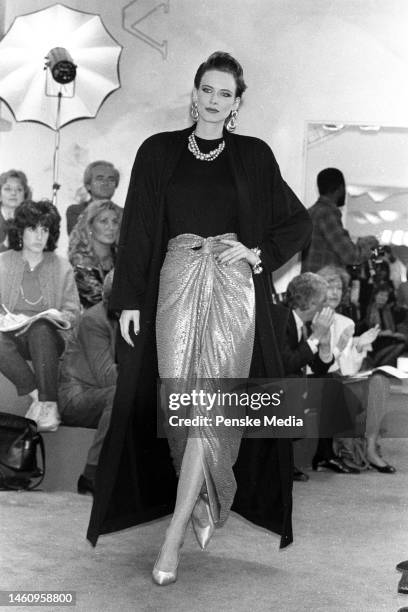 Model on the runway of the Donna Karan fall 1985 ready to wear collection on May 3, 1985 in New York. Article title: 'Dressed Up Days'; Seven Easy...