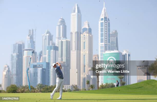 Rory McIlroy of Northern Ireland plays his second shot into the 13th green during the final round of the Hero Dubai Desert Classic at Emirates Golf...