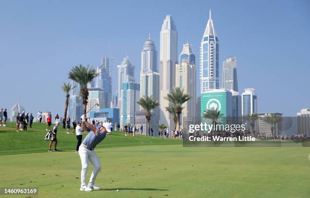 Rory McIlroy of Northern Ireland plays his second shot into the eighth green during the final round of the Hero Dubai Desert Classic at Emirates Golf...