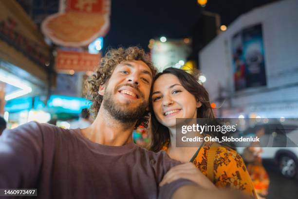 selfie of woman and man in chinatown in bangkok - bangkok nightlife stock pictures, royalty-free photos & images