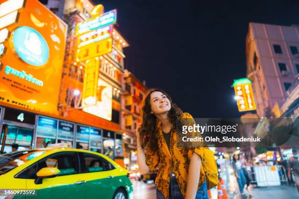 woman walking in chinatown in bangkok - bangkok tourist stock pictures, royalty-free photos & images
