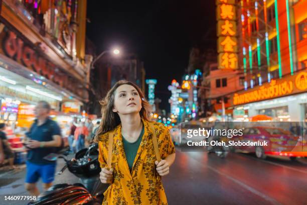 woman walking in chinatown in bangkok - sabbatical stockfoto's en -beelden