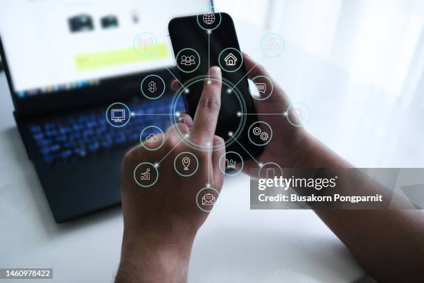 businessman hand working with mobile phone and laptop computer with technology digital graphic - interview icon stock pictures, royalty-free photos & images