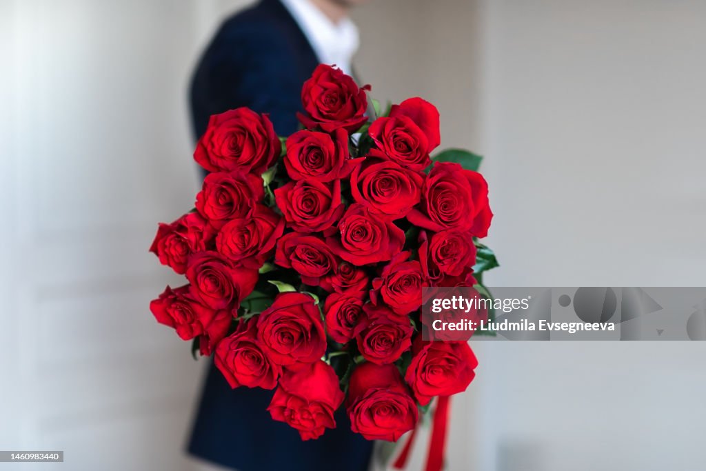 Man with red roses bouquet