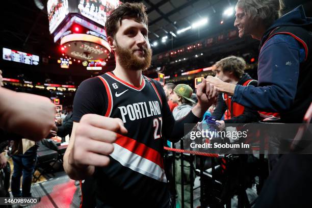 Jusuf Nurkic of the Portland Trail Blazers high fives fans following the NBA game against the Atlanta Hawks at Moda Center on January 30, 2023 in...