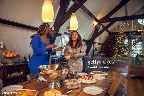 black friends chatting at a christmas dinner party celebration - netherlands christmas stock pictures, royalty-free photos & images
