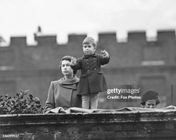 Princess Elizabeth , left, and Prince Charles watching a procession, during the visit of Queen Juliana of the Netherlands, from the wall of Clarence...