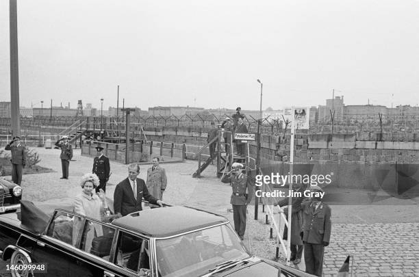 Queen Elizabeth II and Prince Philip by the Berlin Wall at Potsdamer Platz, West Berlin, during their state visit to West Germany, 27th May 1965.