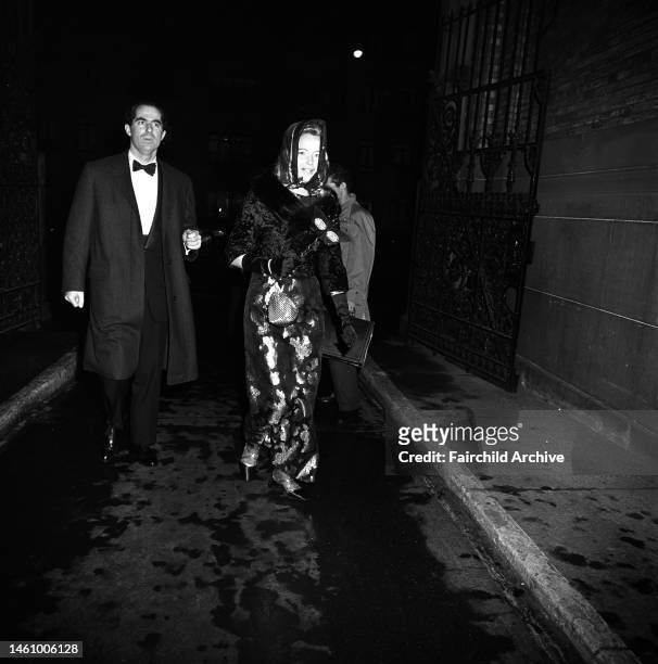 Couple arriving at author Truman Capote's Black and White masquerade ball
