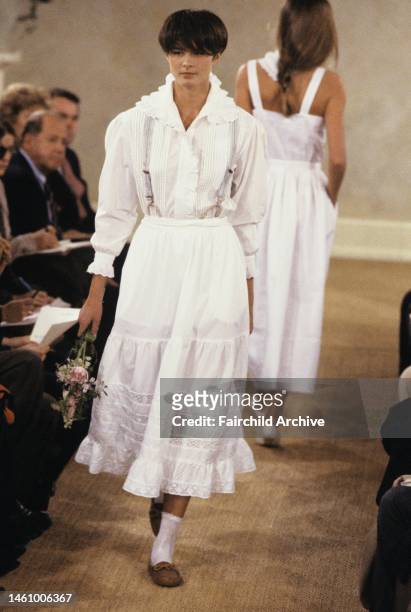 Model wearing petticoat skirt and detailed blouse and suspenders from Ralph Lauren's spring/summer 1989 RTW collection on the runway