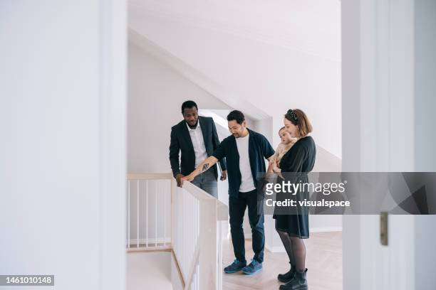 real estate agent showing potential new home to clients - real people family portraits stockfoto's en -beelden