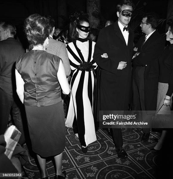 Couple in masks arriving at Truman Capote's Black and White Ball in the Grand Ballroom at the Plaza Hotel in New York City