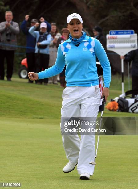 Kelly Tidy of England and the Great Britain and Ireland team celebrates after she had holed a birdie putt on the 17th hole to win her match during...