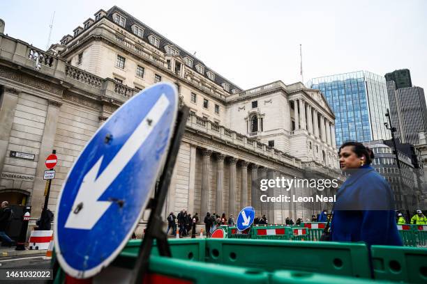 Road signs featuring downward pointing arrows are seen outside the Bank of England during the morning rush hour on January 31, 2023 in London, United...