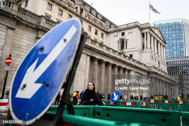 Road signs featuring downward pointing arrows are seen outside the Bank of England during the morning rush hour on January 31, 2023 in London, United...