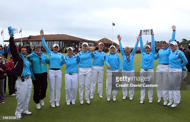 The ecstatic Great Britain and Ireland team celebrate on the 18th green during the final day singlesl matches in the 37th Curtis Cup Match held at...