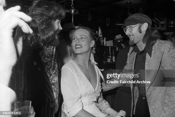 Margaux Hemingway talking with guests at her party