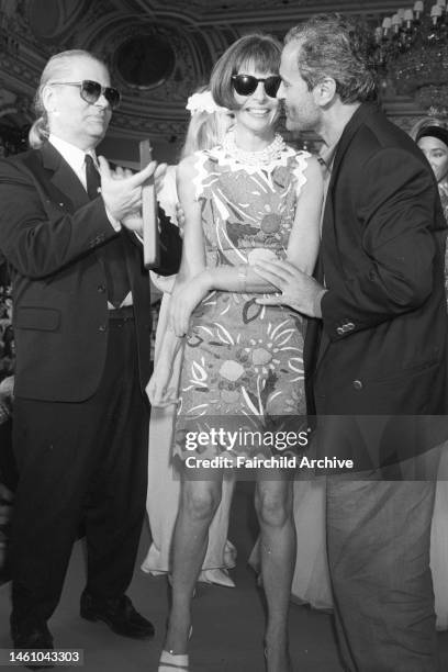 Fashion designers Karl Lagerfeld and Gianni Versace with Anna Wintour on stage during the finale of the Fashion Group and Vogue's celebration of fall...