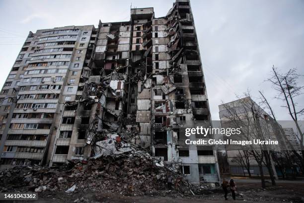 Two girls stand near a residential building destroyed by Russian shelling on January 30, 2023 in Kharkiv, Ukraine. Pivnichna Saltivka is a...