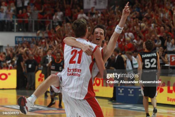 Tibor Pleiss of Bamberg celebrates victory with his team mate Casey Jacobsen after winning game 3 of the Beko BBL finals between Brose Baskets and...