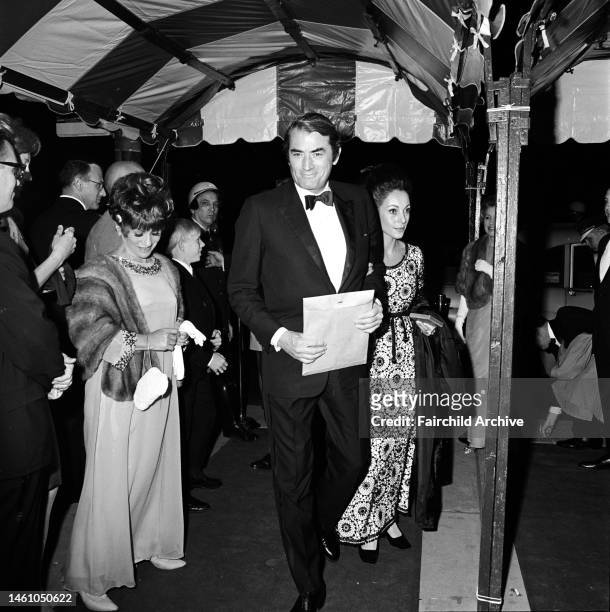 Actor Gregory Peck with wife Veronique arriving at the Orchestra Hall in Chicago for the Joseph P. Kennedy Awards in mental retardation