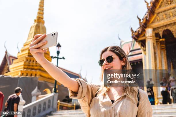 young woman exploring the grand palace in bangkok - thailand tourist stock pictures, royalty-free photos & images