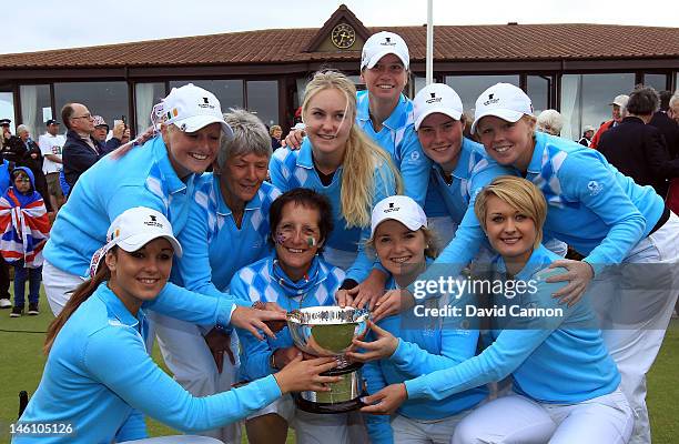 The victorious Great Britain and Ireland team with the Curtis Cup after their ten and a half to nine and a half win during the final day singles...