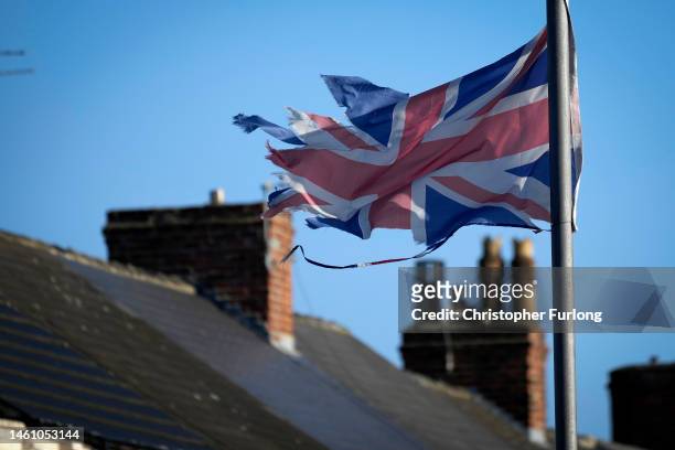 Bedraggled and wind torn Union flag flys over homes on January 31, 2023 in Hartlepool, United Kingdom. Today marks the 3rd anniversary of Brexit when...