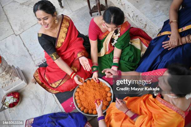 high angle view of indian women having fun while making indian sweet (motichur) laddoos - hindu festival preparation stock pictures, royalty-free photos & images