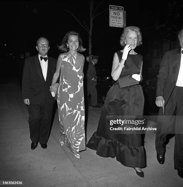 Truman Capote, Lee Radziwell and Rachel Lambert Lloyd arriving at an event at the Asia House hosted by Jacqueline Kennedy for John K. Galbraith in...