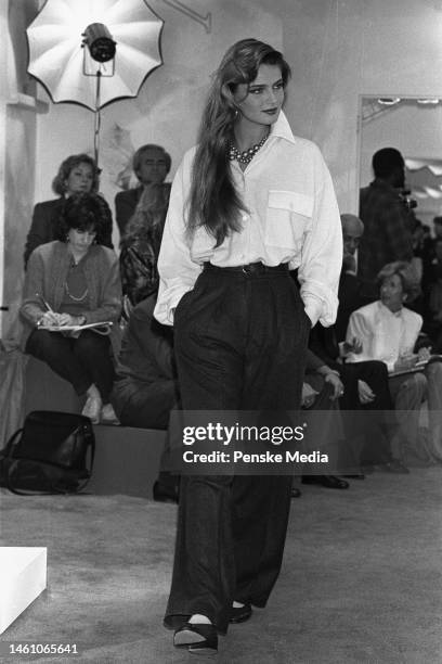 Model on the runway of the Donna Karan fall 1985 ready to wear collection on May 3, 1985 in New York. Article title: 'Dressed Up Days'; Seven Easy...