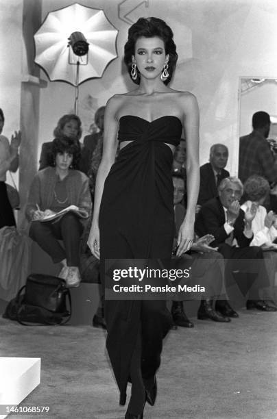 Model on the runway of the Donna Karan fall 1985 ready to wear collection on May 3, 1985 in New York. Article title: 'Dressed Up Days'; Seven Easy...