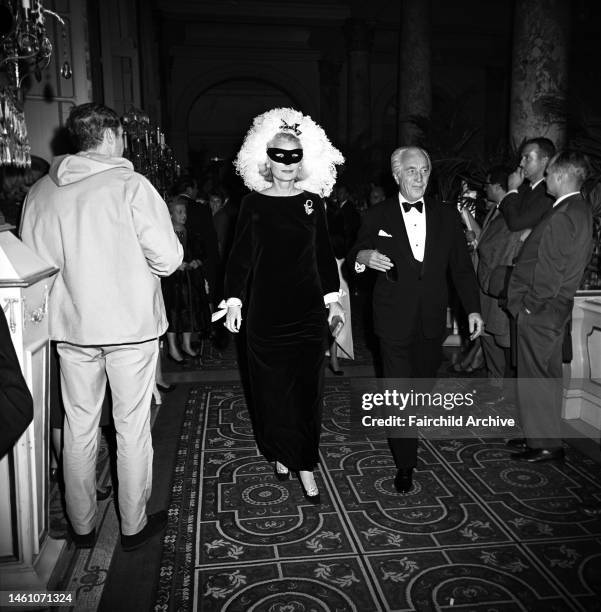 Couple arriving at Truman Capote's Black and White Ball in the Grand Ballroom at the Plaza Hotel in New York City