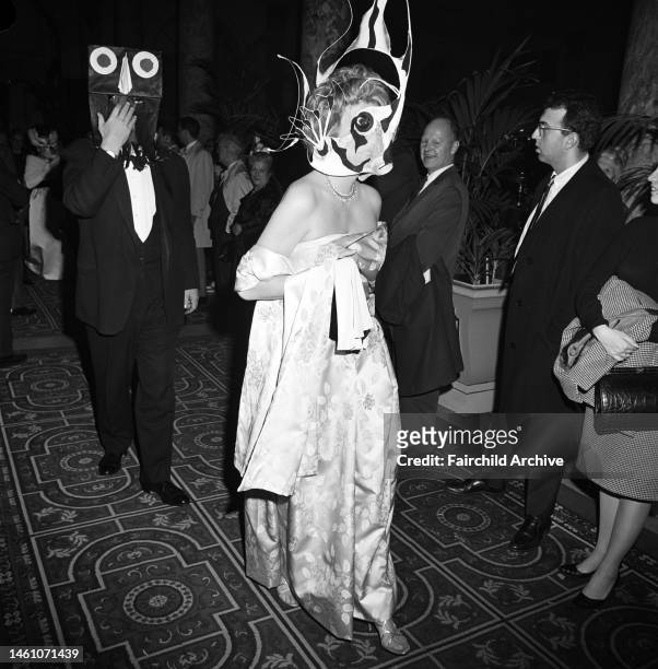 Couple in masks arriving at Truman Capote's Black and White Ball in the Grand Ballroom at the Plaza Hotel in New York City