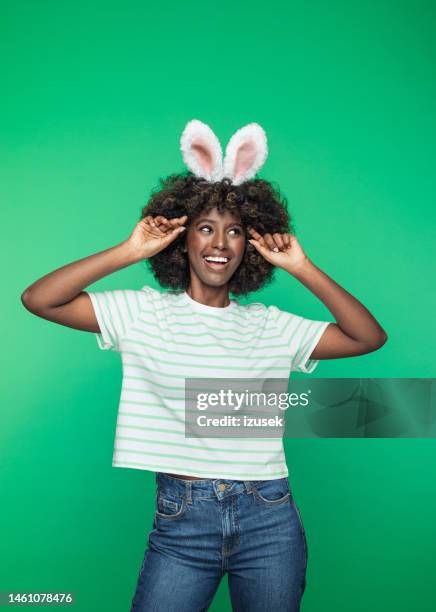 spring portrait of young woman with rabbit ears headband - bunny ears stockfoto's en -beelden