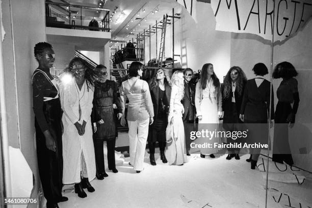 Located at Margiela's storefront window in Charivari 57, models pose in a semi-circle during the unveiling of Martin Margiela's fall collection....