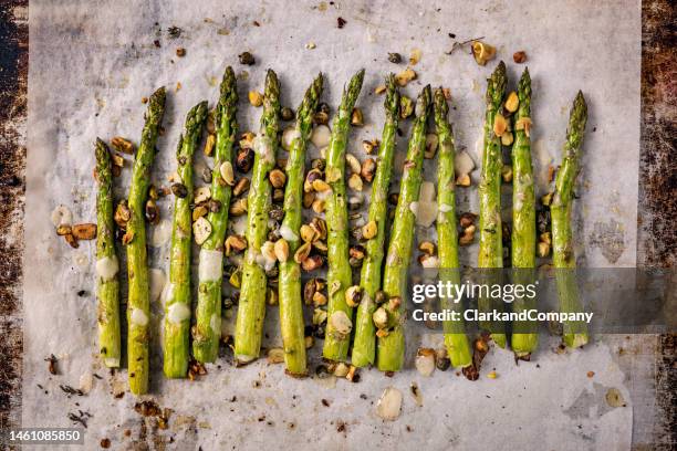 roasted asparagus with pistachios and thyme. - asparagus stock pictures, royalty-free photos & images