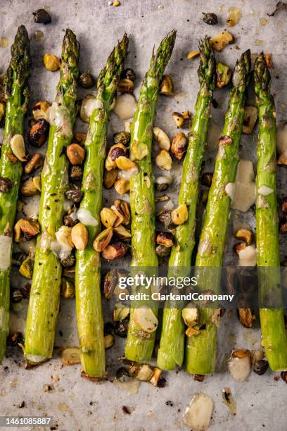 roasted asparagus with pistachios and thyme. - asparagus stock pictures, royalty-free photos & images