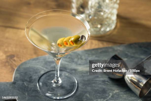 high angle view of wine in glass on table,united states,usa - dirty martini stock-fotos und bilder