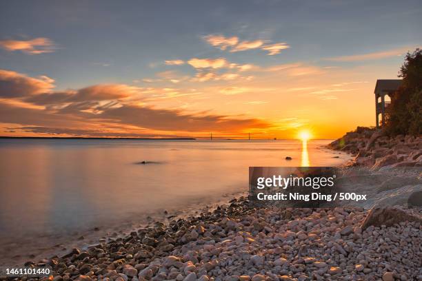 scenic view of sea against sky during sunset,mackinac island,michigan,united states,usa - mackinac island ストックフォトと画像