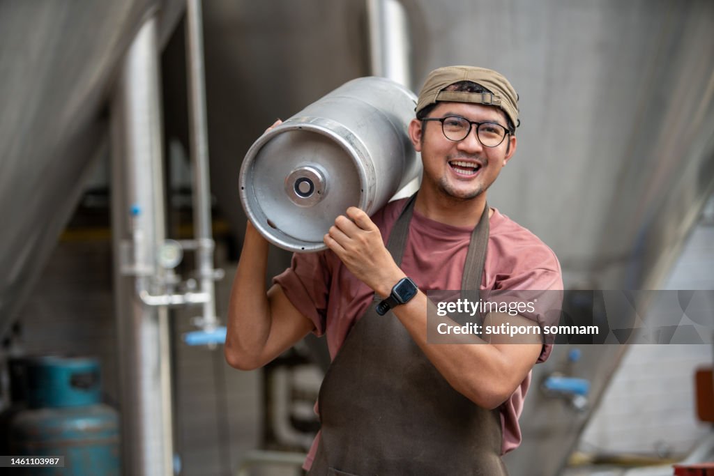 Brewers enjoy carrying beer kegs at the brewery.