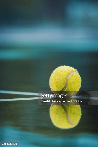 close-up of tennis ball on court,riau,indonesia - tennis raquet close up photos et images de collection