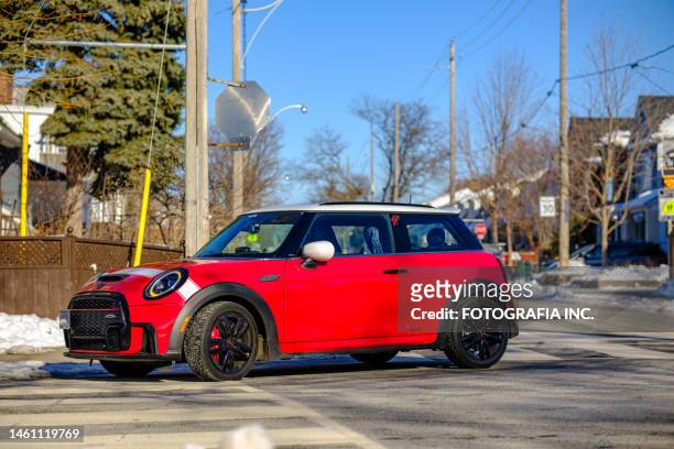 2023 mini cooper jcw on the winter city street - cooper stock pictures, royalty-free photos & images