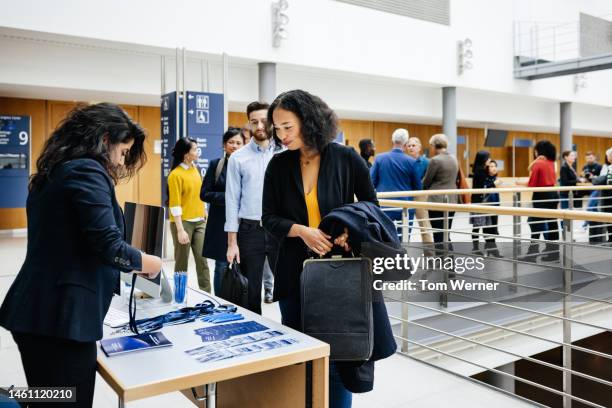 attendees signing in at business conference registration desk - corporate business card stock pictures, royalty-free photos & images