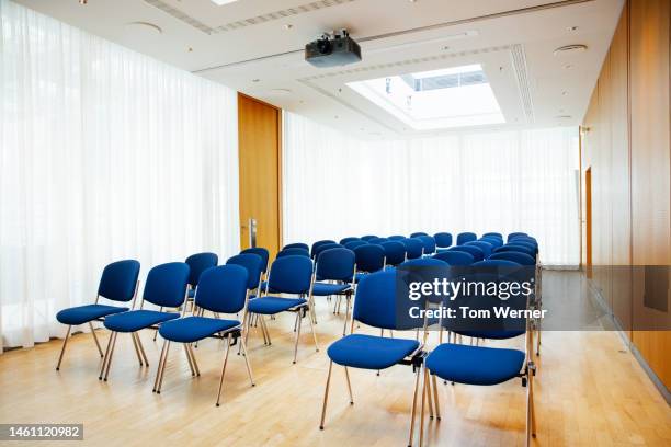 an empty boardroom with seating for business conference attendees - chairs in a row stock pictures, royalty-free photos & images