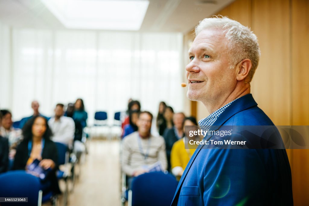 Speaker Looking Back While Giving Presentation
