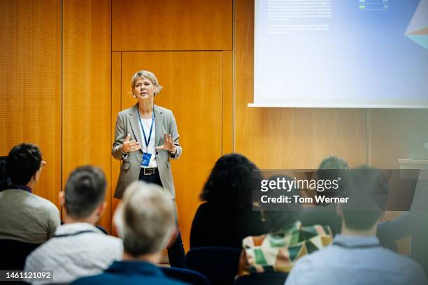 presentation being given by businesswoman at conference - announcement foto e immagini stock