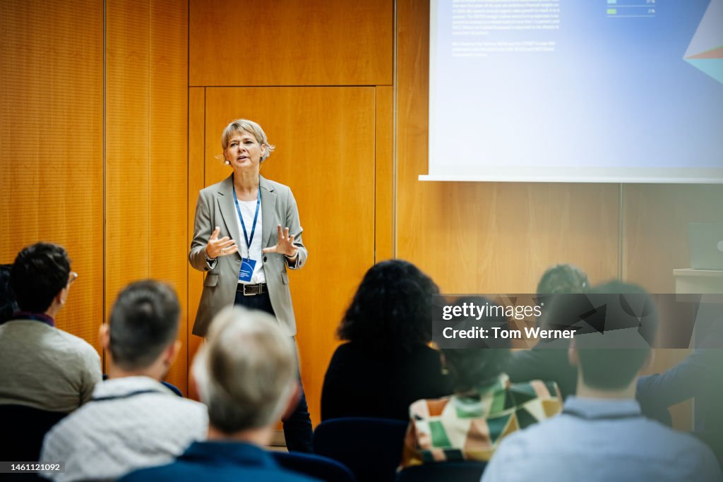 Presentation Being Given By Businesswoman At Conference