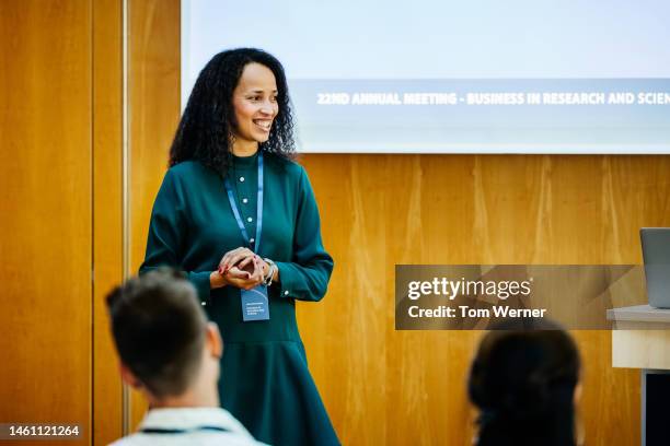 woman giving talking on general business at conference - questions answered stock pictures, royalty-free photos & images