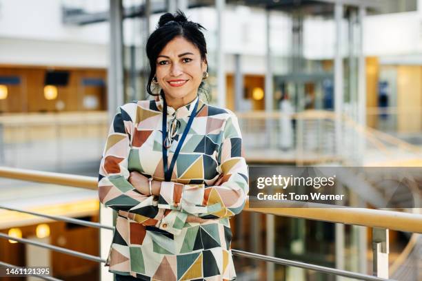 portrait of fashionable businesswoman with arms crossed - participant stock-fotos und bilder